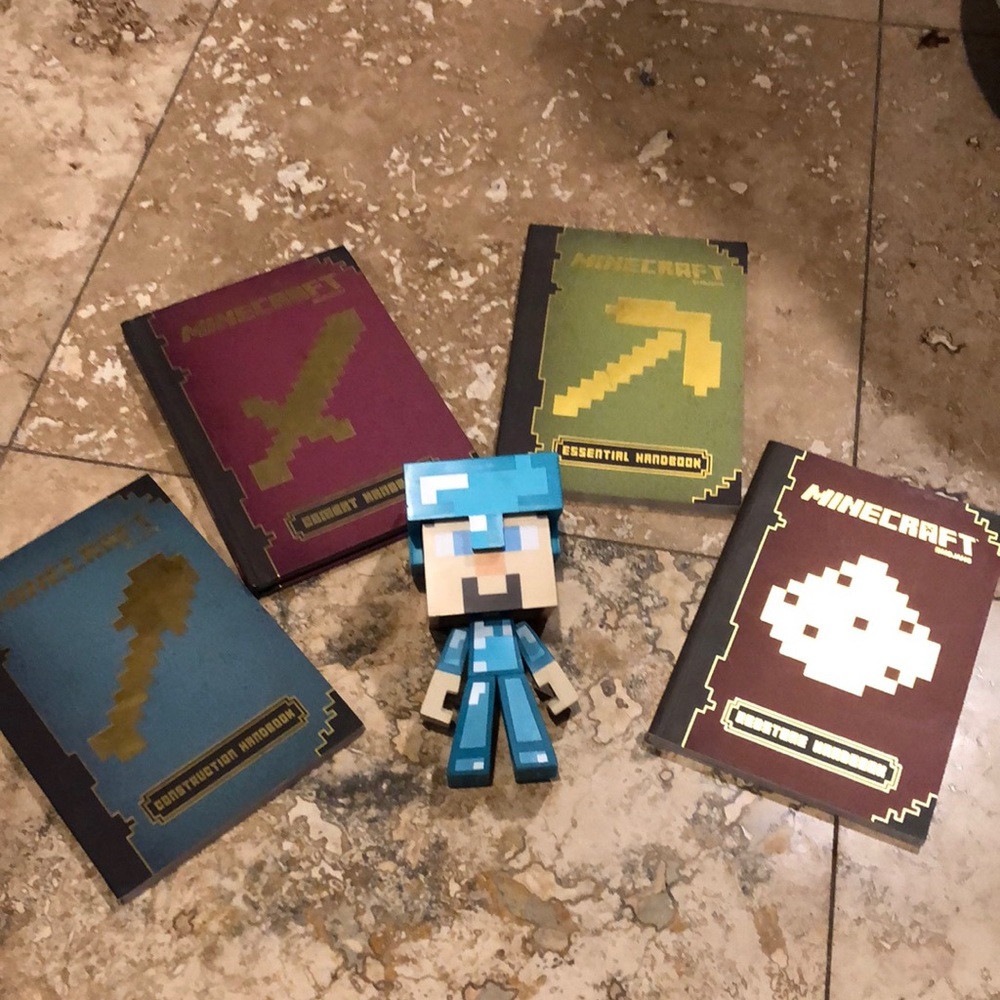 Four new (4) Minecraft Books and vinyl Steve figure